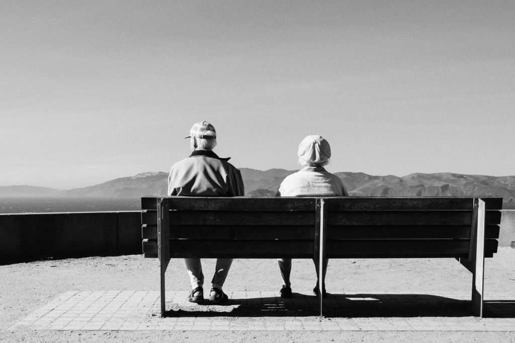 Deux personnes âgées assise sur un banc dans un contexte de médiation familiale ou de droit de la famille.